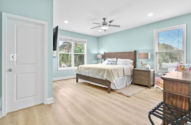 Bedroom with baseboards, light wood-type flooring, recessed lighting, and a ceiling fan | Image 12