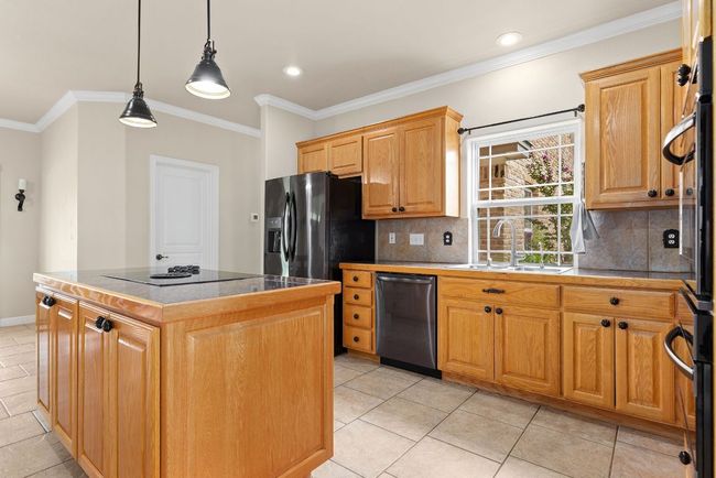 Spacious kitchen with center island. | Image 11