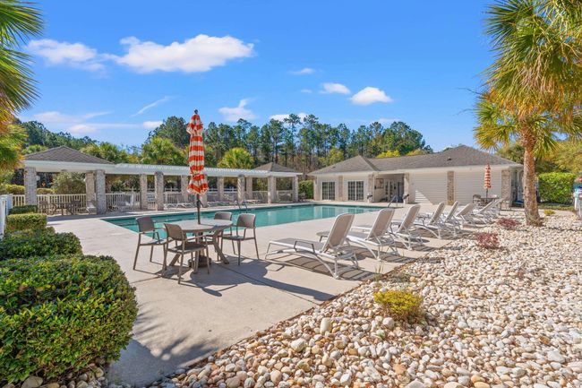 Community pool with a patio area and fence | Image 38