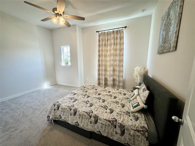 Bedroom with carpet floors, a ceiling fan, and baseboards | Image 13