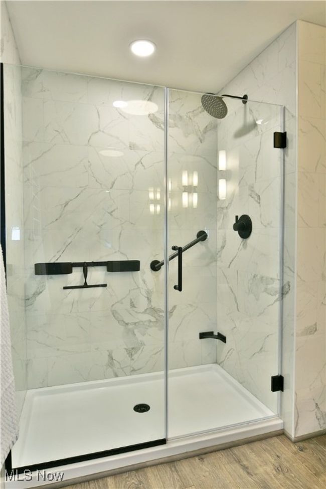 Full bathroom featuring a marble finish shower and wood finished floors | Image 31