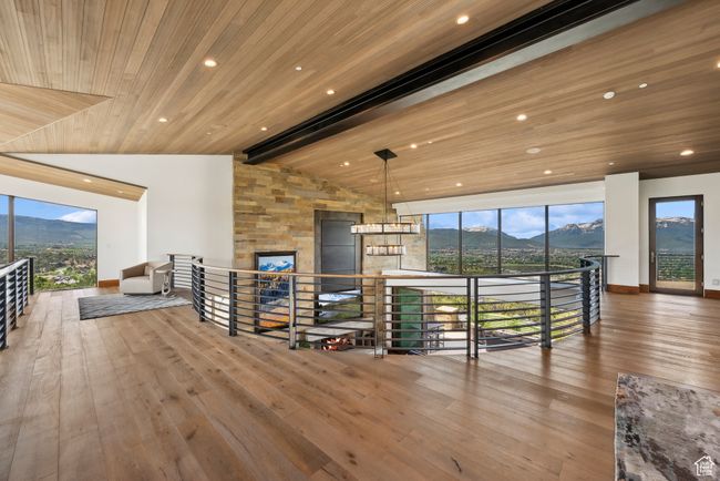 Living area with wood ceiling, a mountain view, wood-type flooring, plenty of natural light, and recessed lighting | Image 102