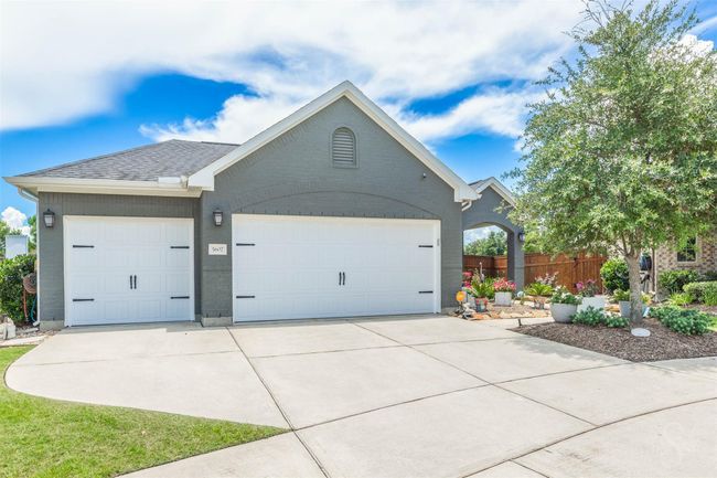 A sleek garage door, updated in 2023, featuring a three-layer premium + insulated system for superior energy efficiency. It offers a 5-year labor service warranty and a lifetime spring warranty, ensuring long-lasting durability and peace of mind. | Image 9