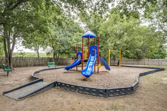 The playground is located at the amenity center, near the pool. Cool days and early evenings are prime times to find gatherings of families enjoying the park-like setting of the playground. | Image 36