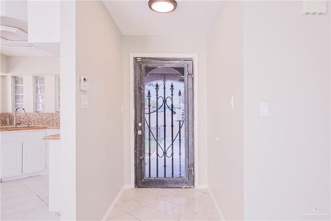 Foyer entrance featuring light tile patterned floors and baseboards | Image 6