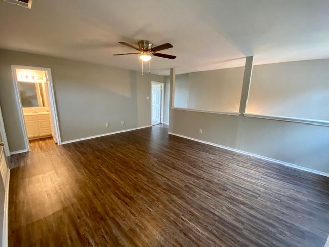 Unfurnished room with dark wood finished floors and a ceiling fan | Image 19