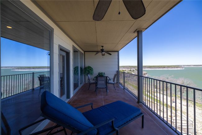 Balcony with a water view and a ceiling fan | Image 14