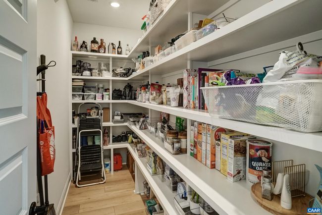 Spacious walk in pantry with solid shelves. | Image 24