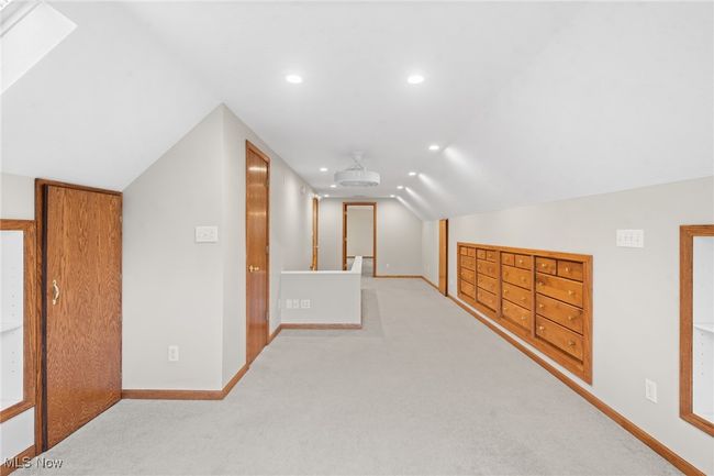 Bonus room featuring light colored carpet and lofted ceiling with skylight | Image 15