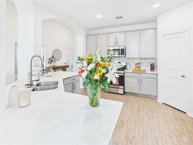 Kitchen featuring stainless steel appliances, a sink, gray cabinets, and recessed lighting | Image 11