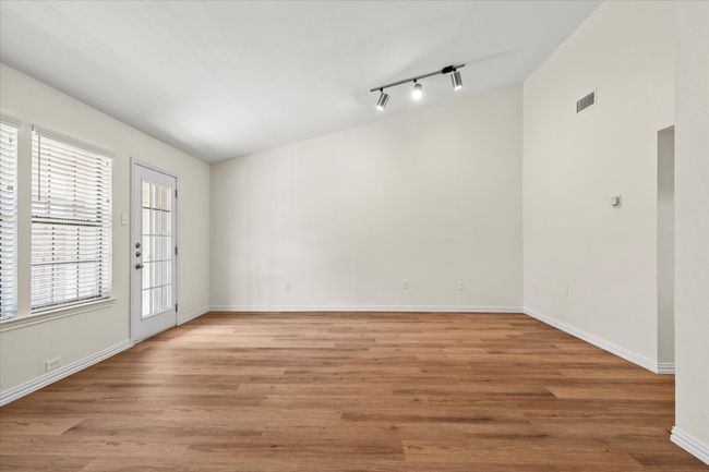 Vaulted ceiling makes the living room feel extra spacious | Image 11