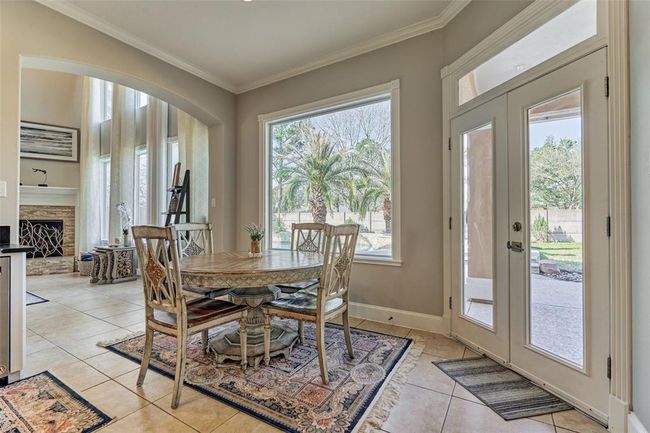 Enjoy stunning views of the backyard, kitchen, and living area from this cozy breakfast room. | Image 13