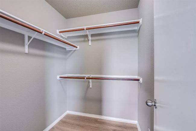 Walk in closet featuring wood finished floors | Image 12