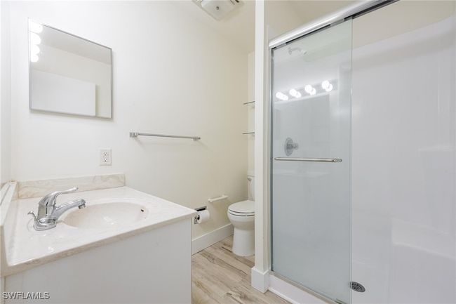 Bathroom featuring single vanity and shower with a sliding glass door | Image 26