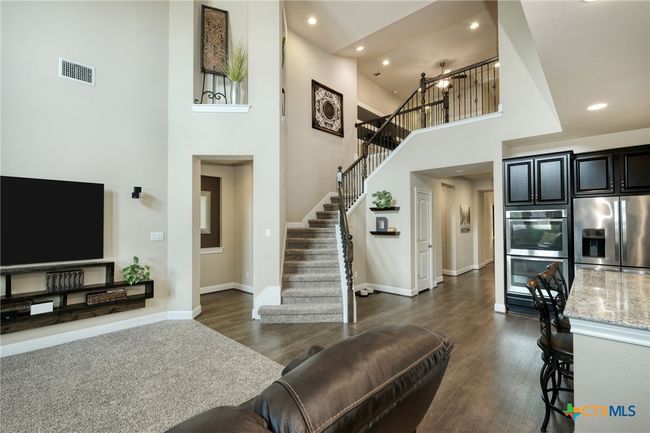 Great room with lots of natural light, high ceilings and ceiling fan | Image 7