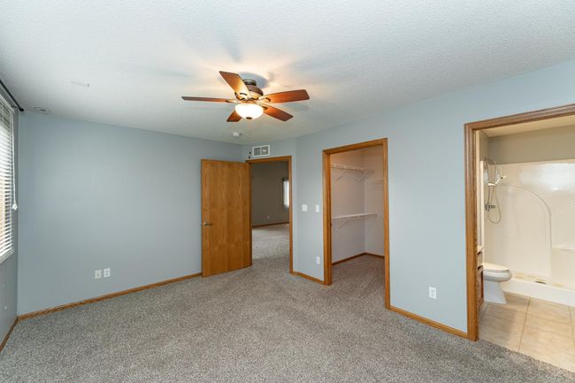 Nice-sized walk-in closet and bath with step-in shower. | Image 10