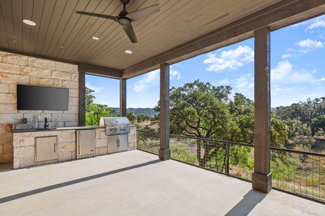 Outdoor kitchen and additional entertaining space on lower level. | Image 26