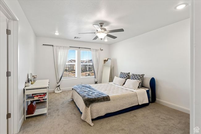 Bedroom with light colored carpet, ceiling fan, and recessed lighting | Image 18