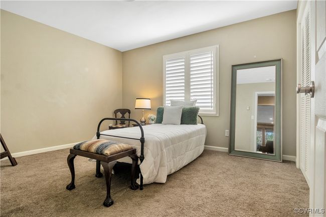 Carpeted bedroom featuring baseboards | Image 17
