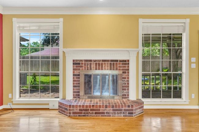 Fireplace in the family room and hard wood floors. | Image 10