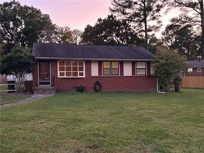 View of front facade with a yard | Image 1