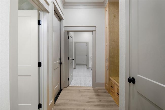 Hall featuring light wood finished floors and crown molding | Image 15