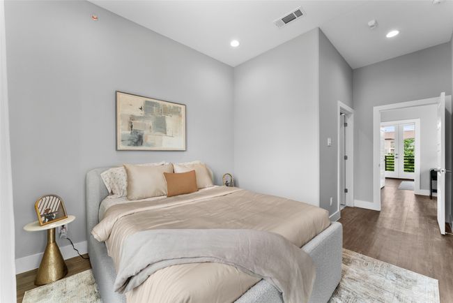 Bedroom with baseboards, recessed lighting, wood finished floors, and visible vents | Image 11
