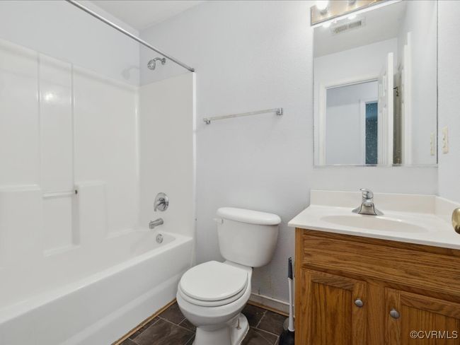 Bathroom featuring vanity, shower / tub combination, and tile patterned floors | Image 23