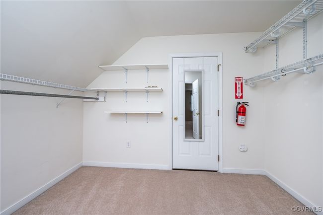 Spacious closet featuring carpet and vaulted ceiling | Image 32