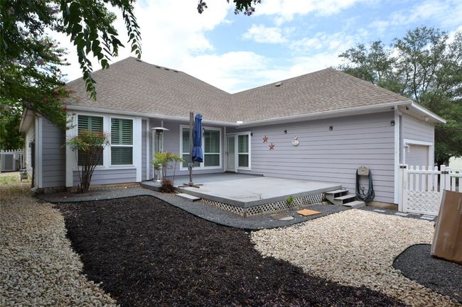Back of house with an attached garage and a shingled roof | Image 19