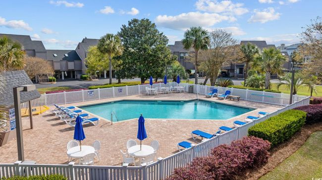 Pool with fence, a patio area, and a residential view | Image 32