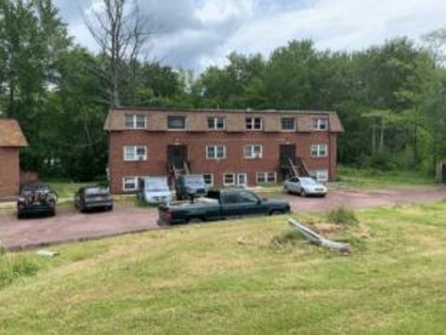 Back of house featuring uncovered parking and a yard | Image 9