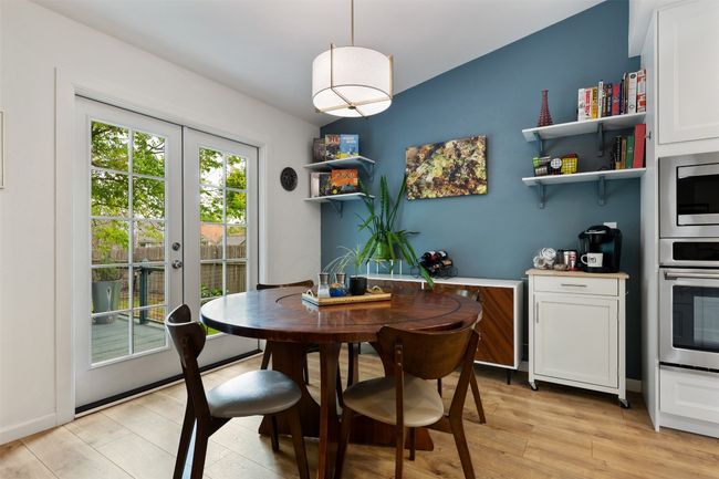Dining space with french doors and light wood-style flooring | Image 11