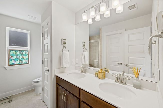 Full bath featuring visible vents, a sink, and toilet | Image 21