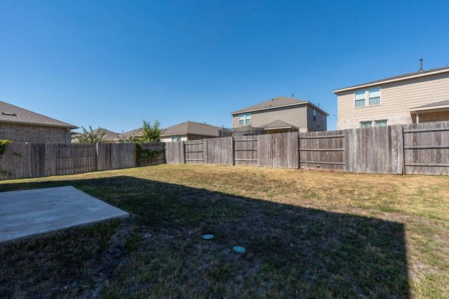 Fenced backyard with a patio area | Image 27