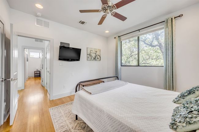 Bedroom featuring ceiling fan and light hardwood / wood-style flooring | Image 30