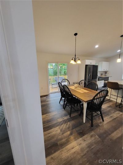 Dining room featuring dark hardwood / wood-style floors and an inviting chandelier | Image 3