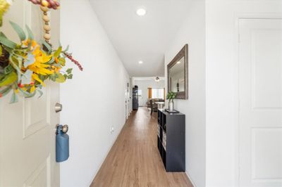 Come on in! To the right is the half bathroom & laundry room and straight ahead, you'll find the open-concept space that includes the dining, living, and kitchen areas. | Image 2