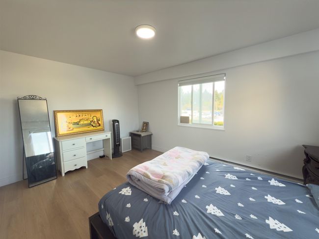 Bedroom with baseboards and wood finished floors | Image 13