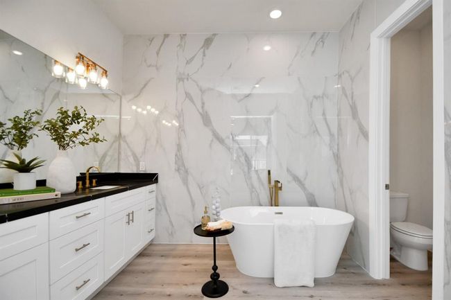 This luxurious primary suite bath is loaded with upgrades. Floor to ceiling tile surround! | Image 17