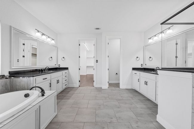 Bathroom with two vanities and a bath | Image 17