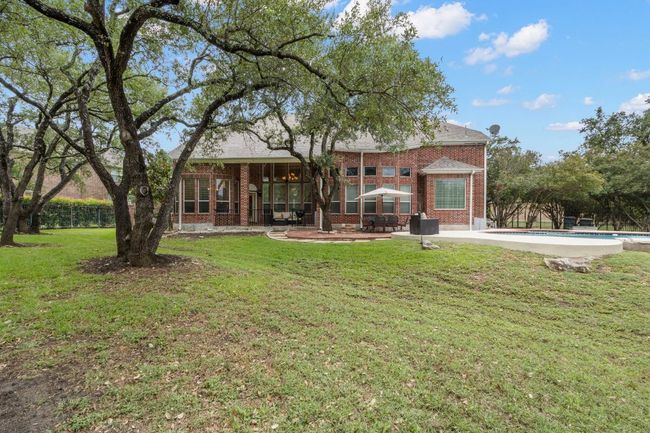 Back of property featuring brick siding and a patio area | Image 39