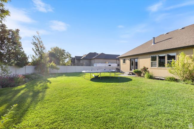 View of yard with a trampoline | Image 20