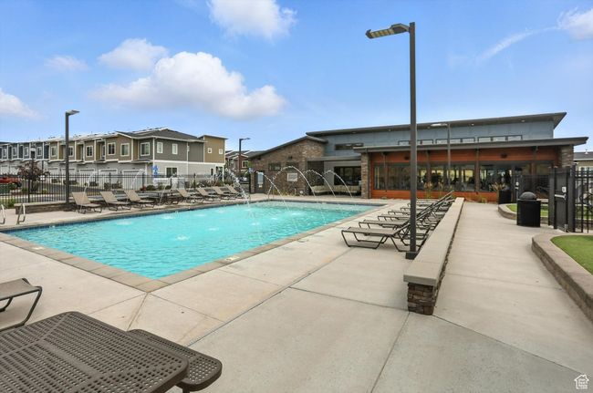 Community pool with a patio area and a residential view and clubhouse | Image 23