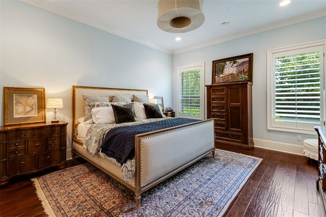 Bedroom featuring baseboards, multiple windows, dark wood-style floors, crown molding, and recessed lighting | Image 10