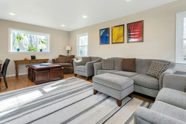 Generously proportioned living room is sun dappled and warm. | Image 13