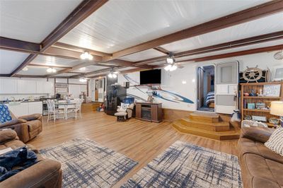 Living room featuring light hardwood / wood-style floors, beam ceiling, and ceiling fan | Image 3