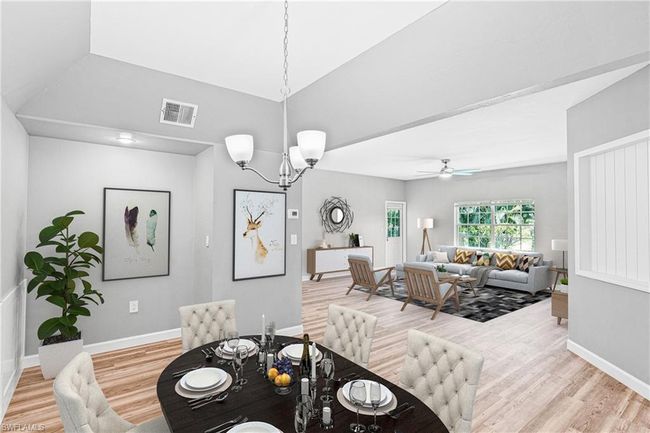 Unfurnished living room with a ceiling fan, a chandelier, and light wood finished floors | Image 24
