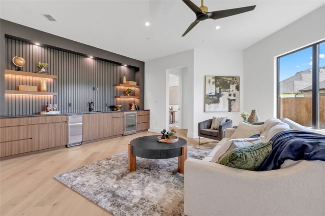 Living room with wine cooler, light wood-style flooring, ceiling fan, and recessed lighting | Image 12