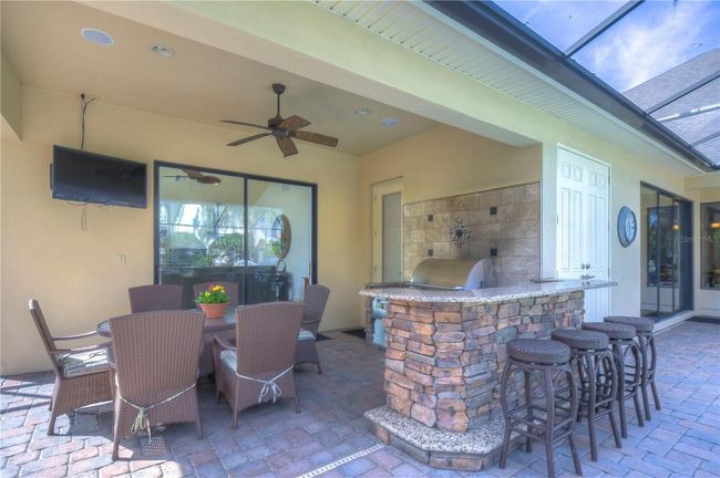 Enjoy alfresco dining under the ceiling fan’s gentle breeze, surrounded by elegant comfort and modern convenience. | Image 30